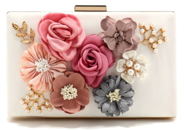 Clutch bag with floral decorations and pearls on a white background