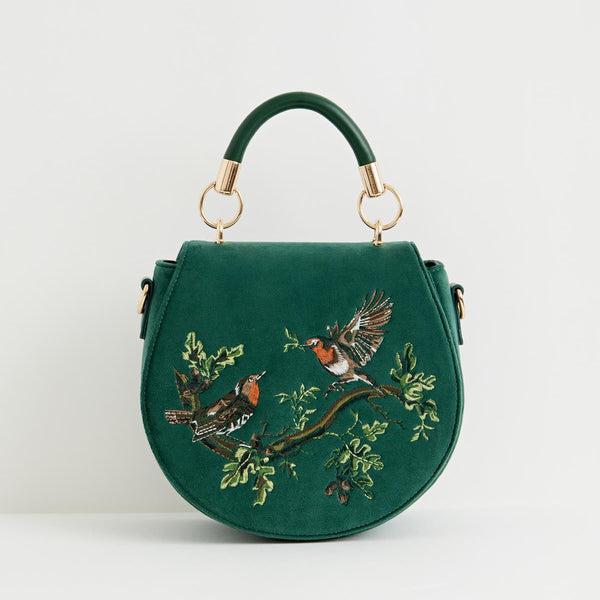 Green handbag with bird embroidery on a white background