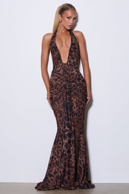 Woman wearing a leopard print evening gown against a white background